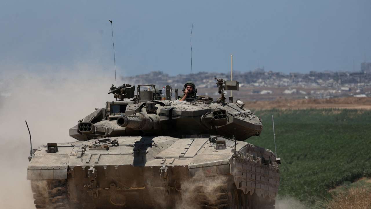 An Israeli tank manoeuvres near the Israel-Gaza border