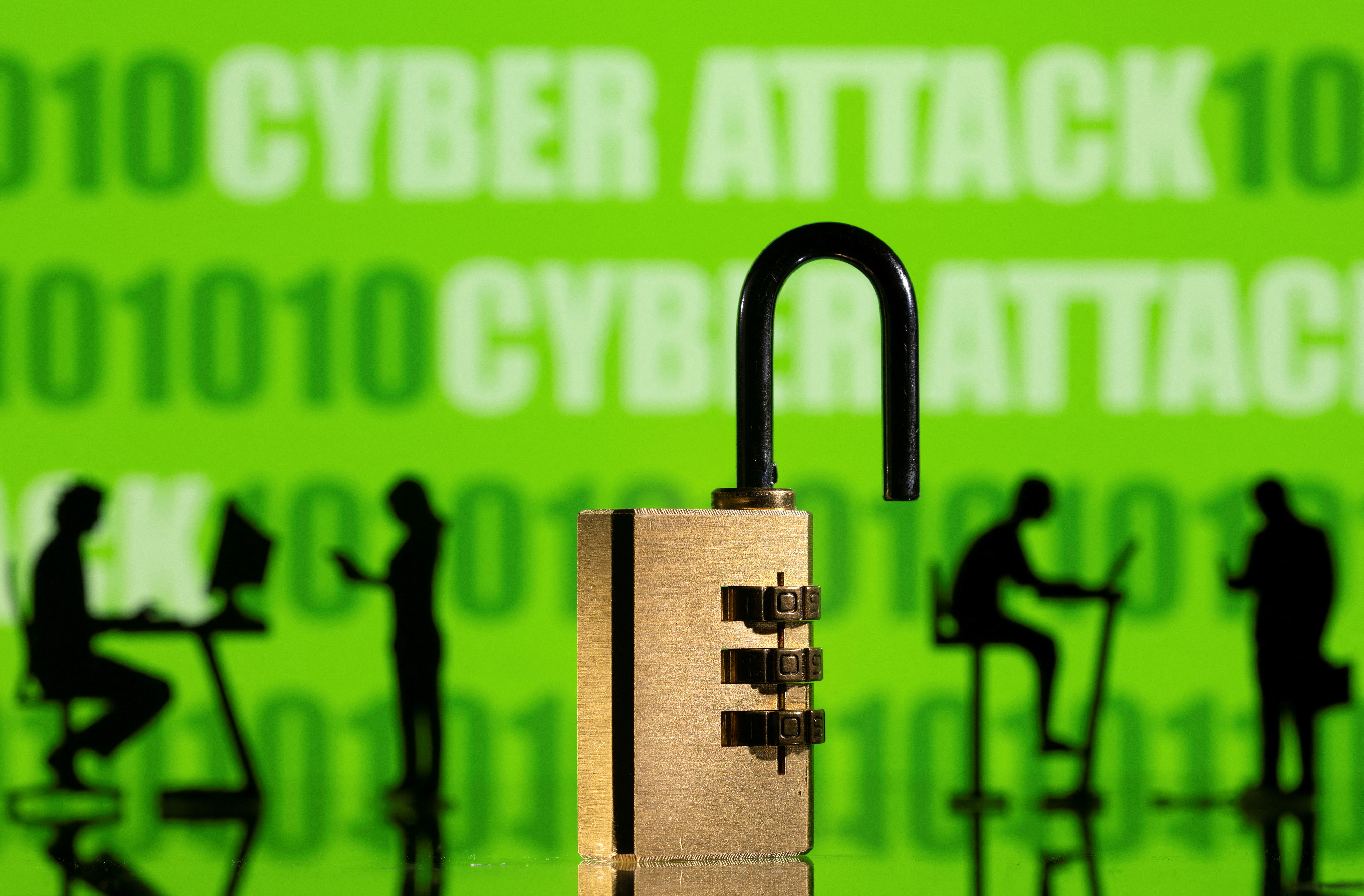 Illustration shows displayed CYBER ATTACK words and binary code