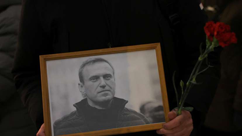 People gather at the monument to the victims of political repressions following the death of Alexei Navalny in Saint Petersburg