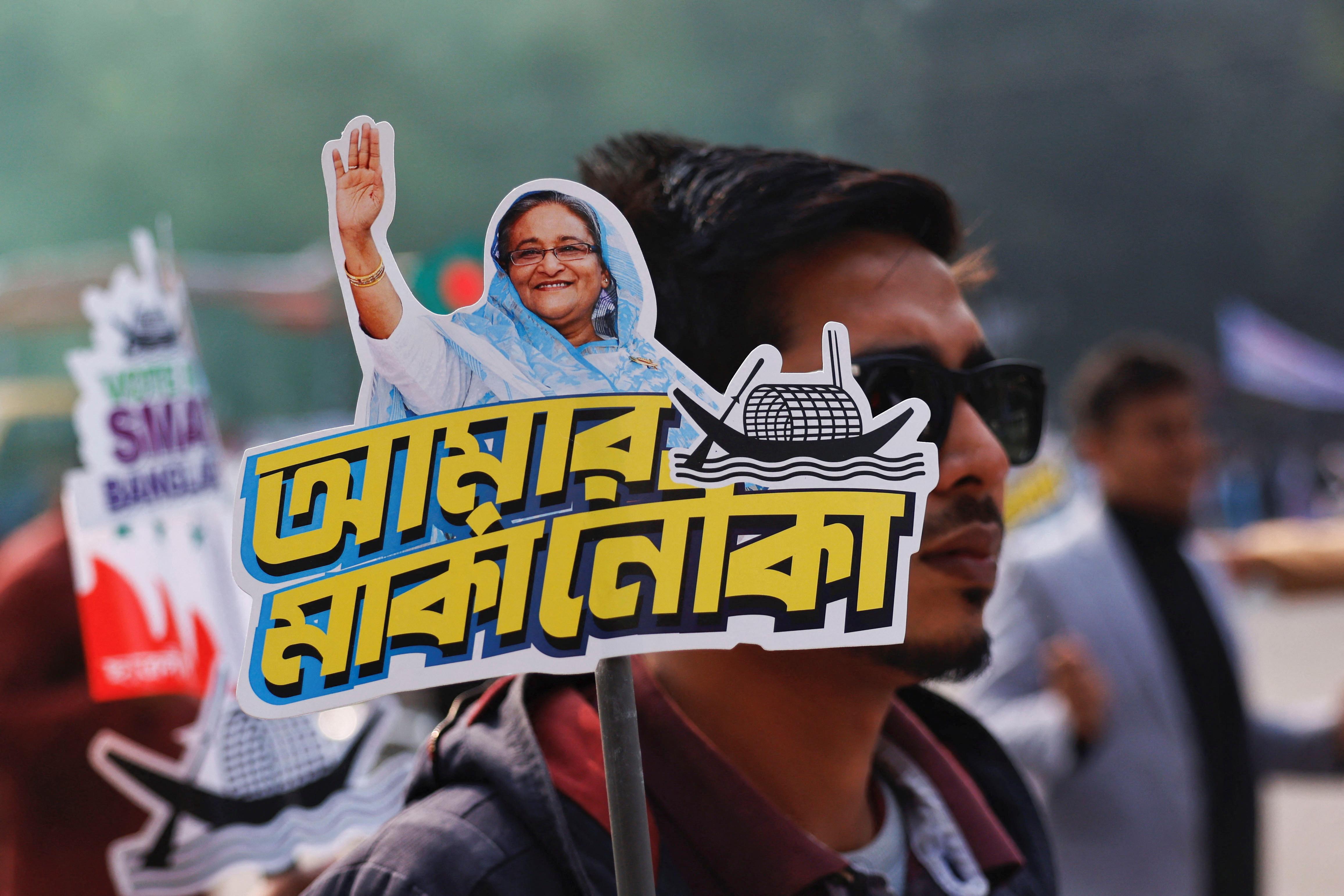 A student holds a placard of Prime Minister Sheikh Hasina as they celebrate the formation day of Bangladesh Chhatra League, in Dhaka