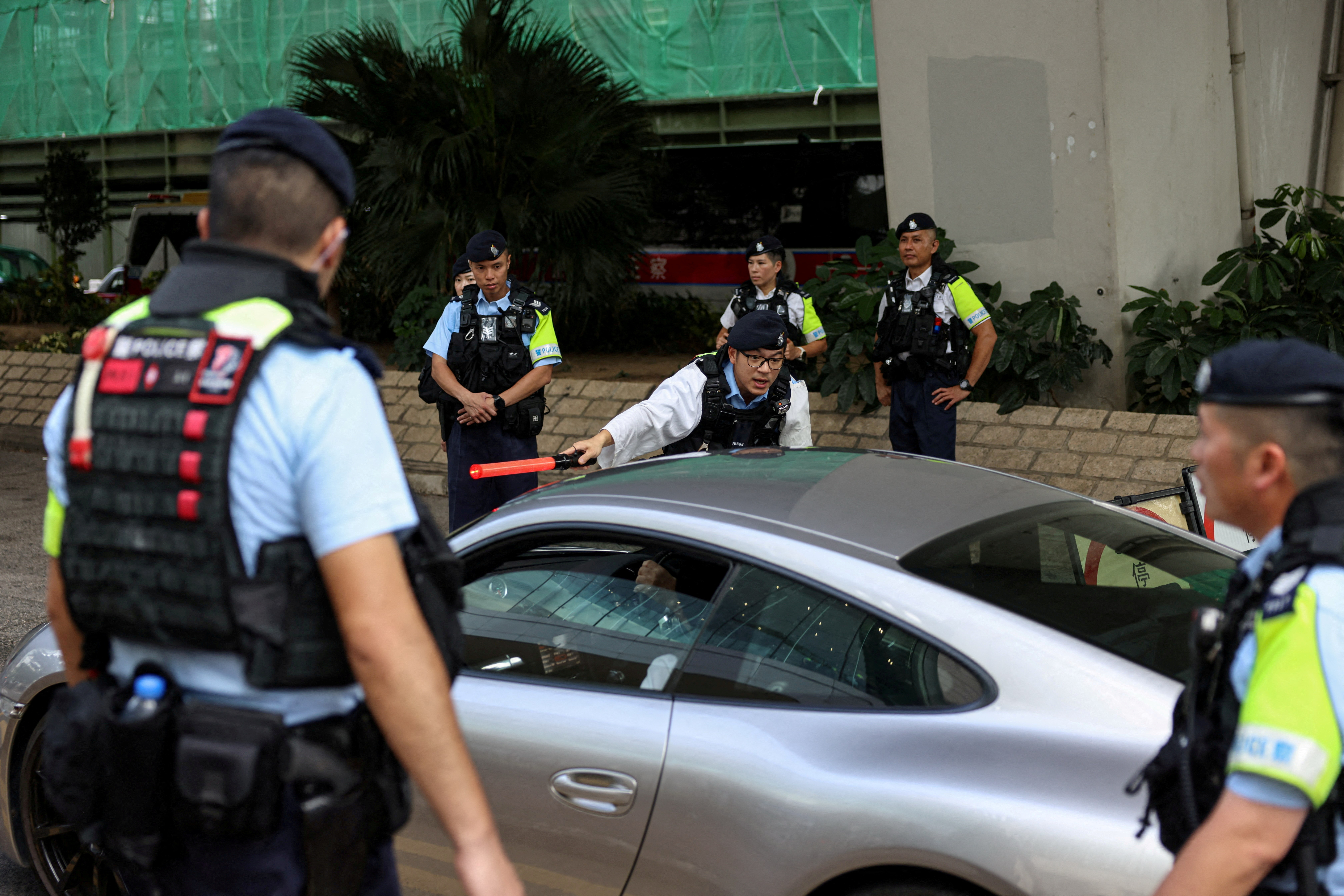 FILE PHOTO: Police officers stand guard at the West Kowloon Magistrates' Courts building, ahead of hearing appeals from 12 jailed pro-democracy activists in Hong Kong