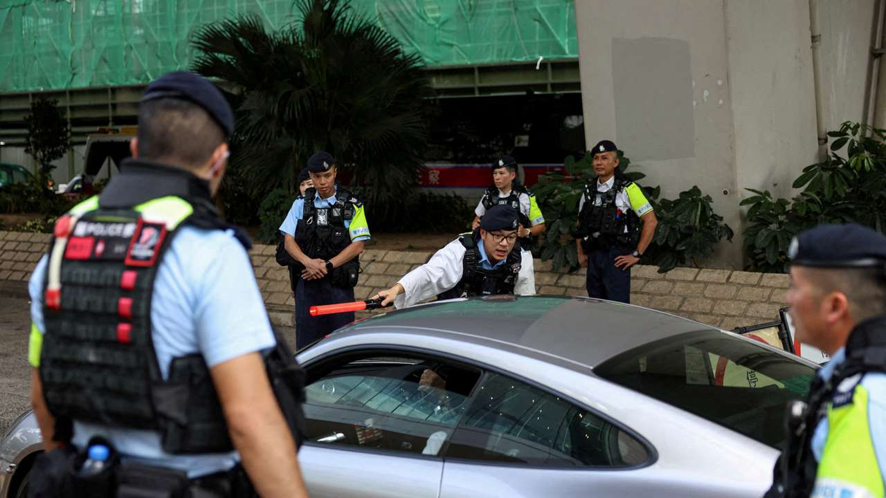 FILE PHOTO: Police officers stand guard at the West Kowloon Magistrates' Courts building, ahead of hearing appeals from 12 jailed pro-democracy activists in Hong Kong
