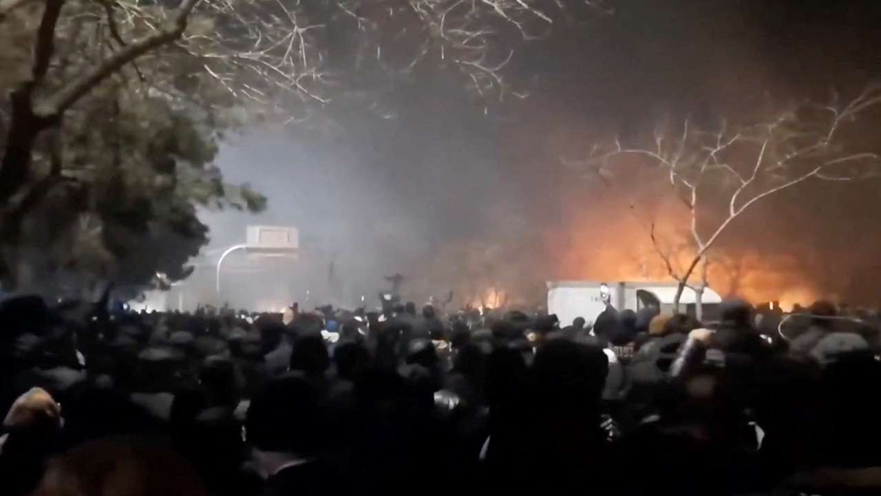 Smoke rises as protesters gather amid evolving anti-government unrest at Vakilabad highway in Mashhad