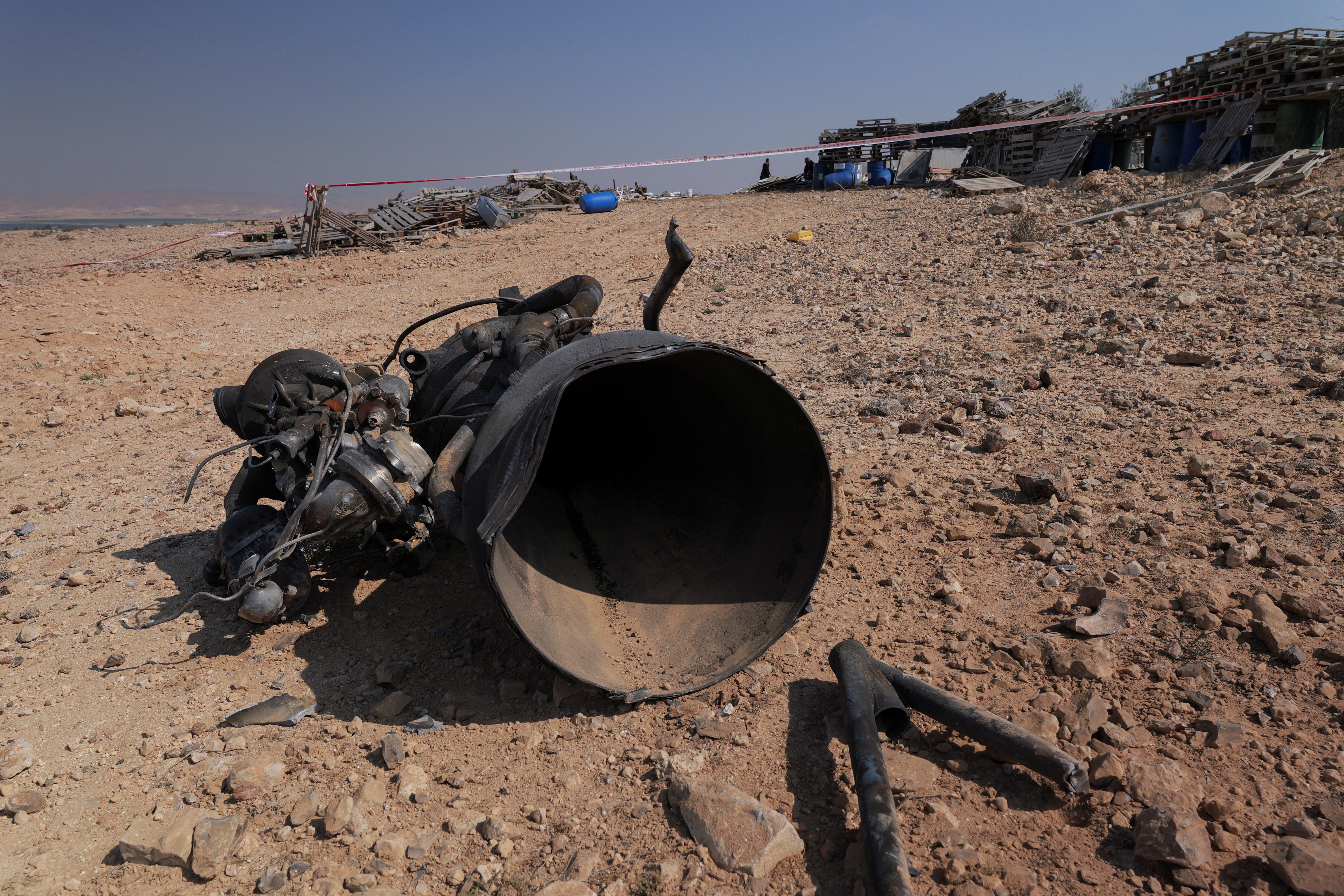 The remains of a rocket booster that, according to Israeli authorities critically injured a 7-year-old girl, after Iran launched drones and missiles towards Israel, near Arad