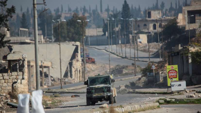 Rebels led by the Islamist militant group Hayat Tahrir al-Sham drive along a street in al-Rashideen, Aleppo province