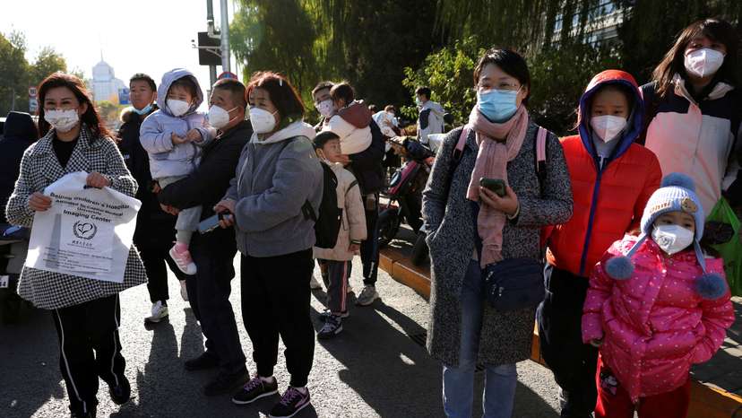 People wait outside a children's hospital in Beijing