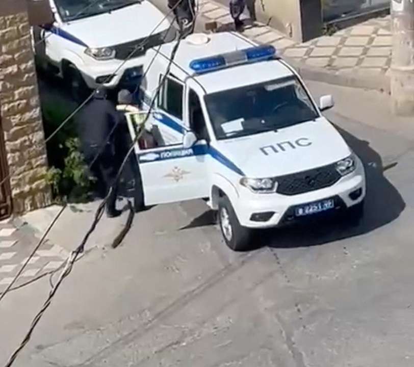 Law enforcement officers operate at the scene of a shootout in Makhachkala