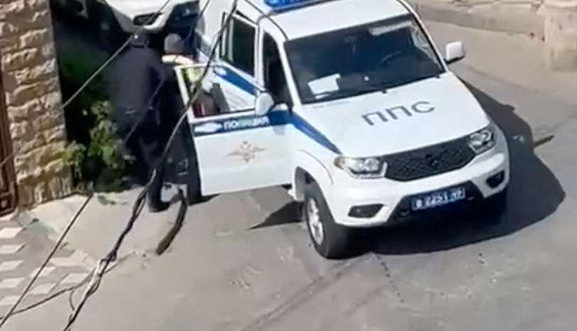 Law enforcement officers operate at the scene of a shootout in Makhachkala