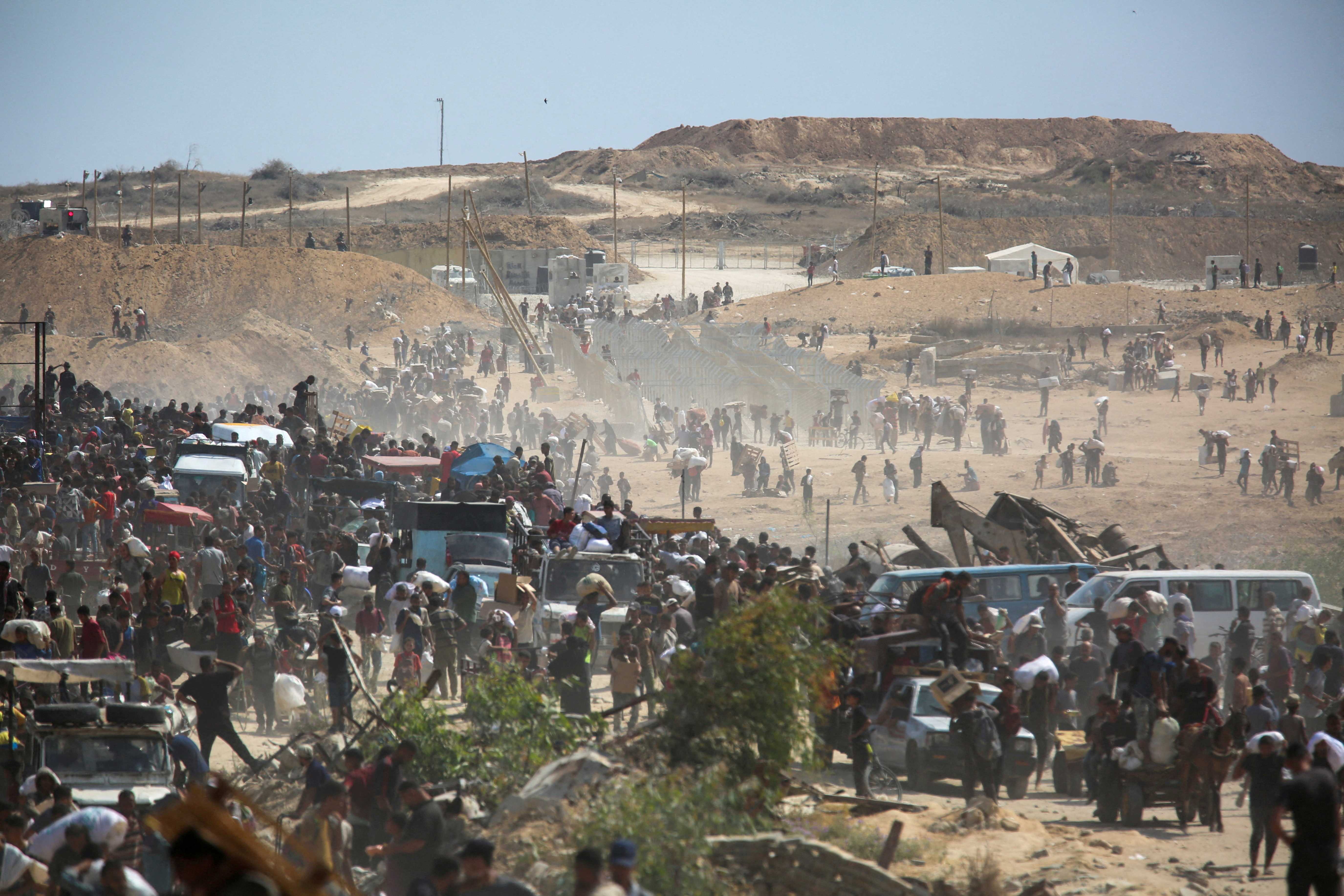 FILE PHOTO: Palestinians seek aid supplies from the U.S.-backed Gaza Humanitarian Foundation (GHF), in the central Gaza Strip