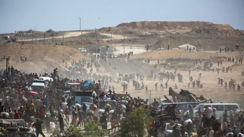 FILE PHOTO: Palestinians seek aid supplies from the U.S.-backed Gaza Humanitarian Foundation (GHF), in the central Gaza Strip