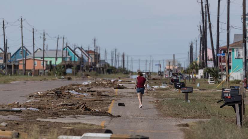 Resident walks past debris in the aftermath of Hurricane Beryl in Surfside Beach, Texas