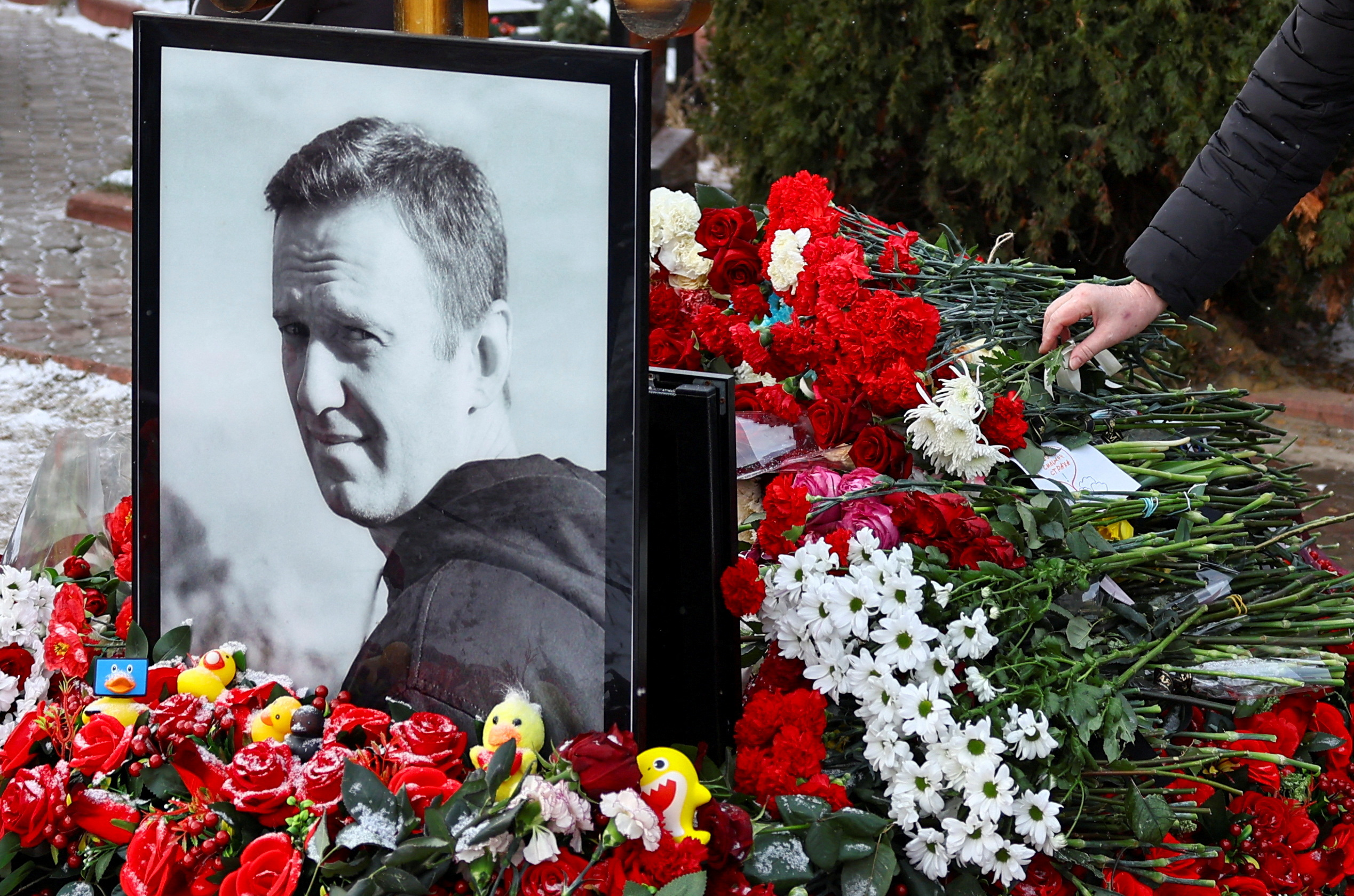 FILE PHOTO: People mark first anniversary of Russian opposition leader Navalny's death at Moscow cemetery