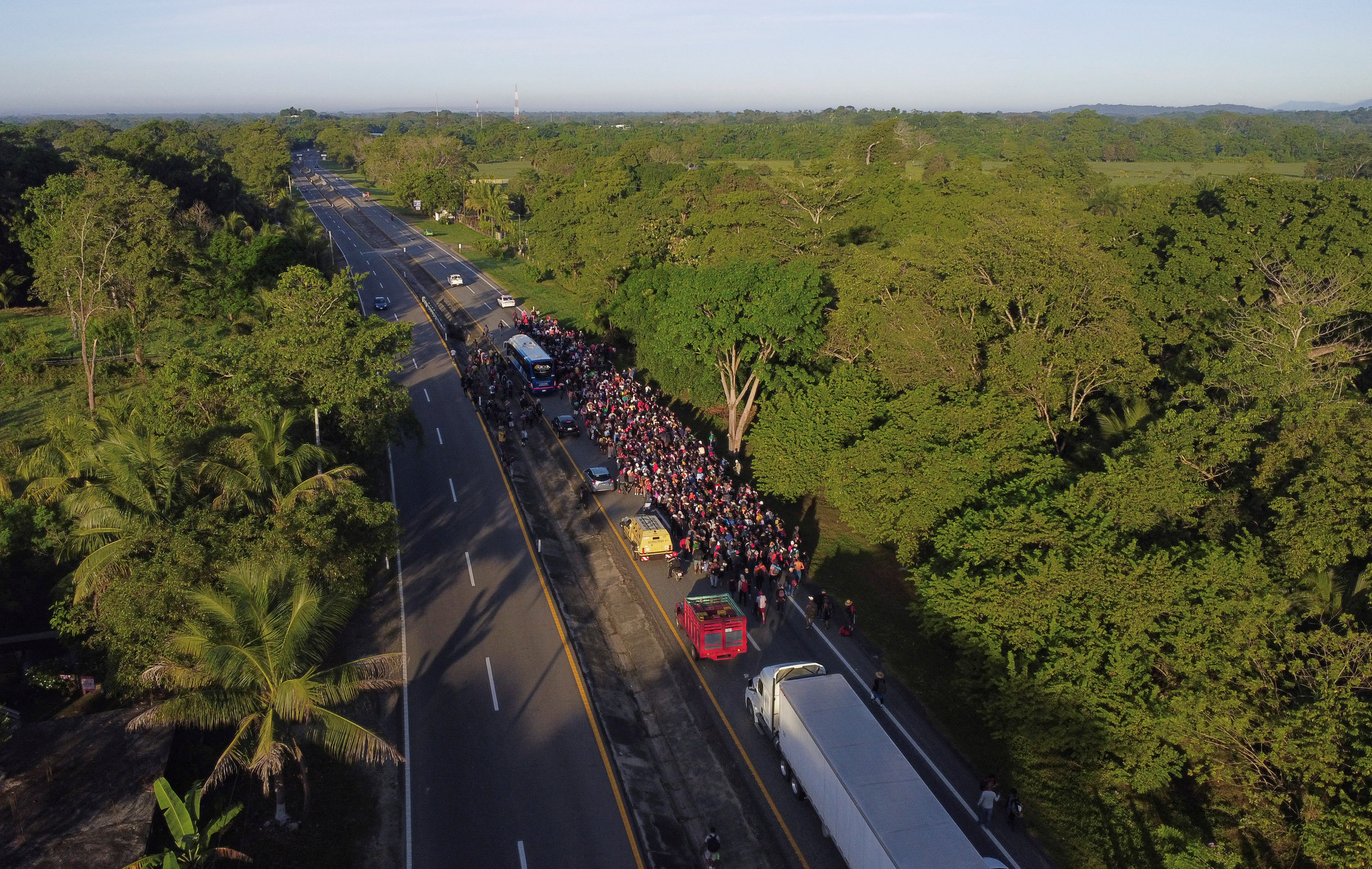 FILE PHOTO: Migrants walk in a caravan in an attempt to reach the U.S. border, in Escuintla