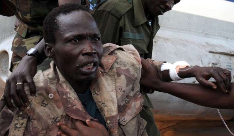 LRA rebel officer Kwoyelo is assisted by Ugandan army upon arrival at Entebbe air force base