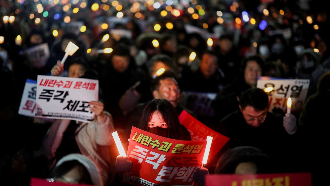 Demonstrators take part in a protest in front of the National Assembly in Seoul