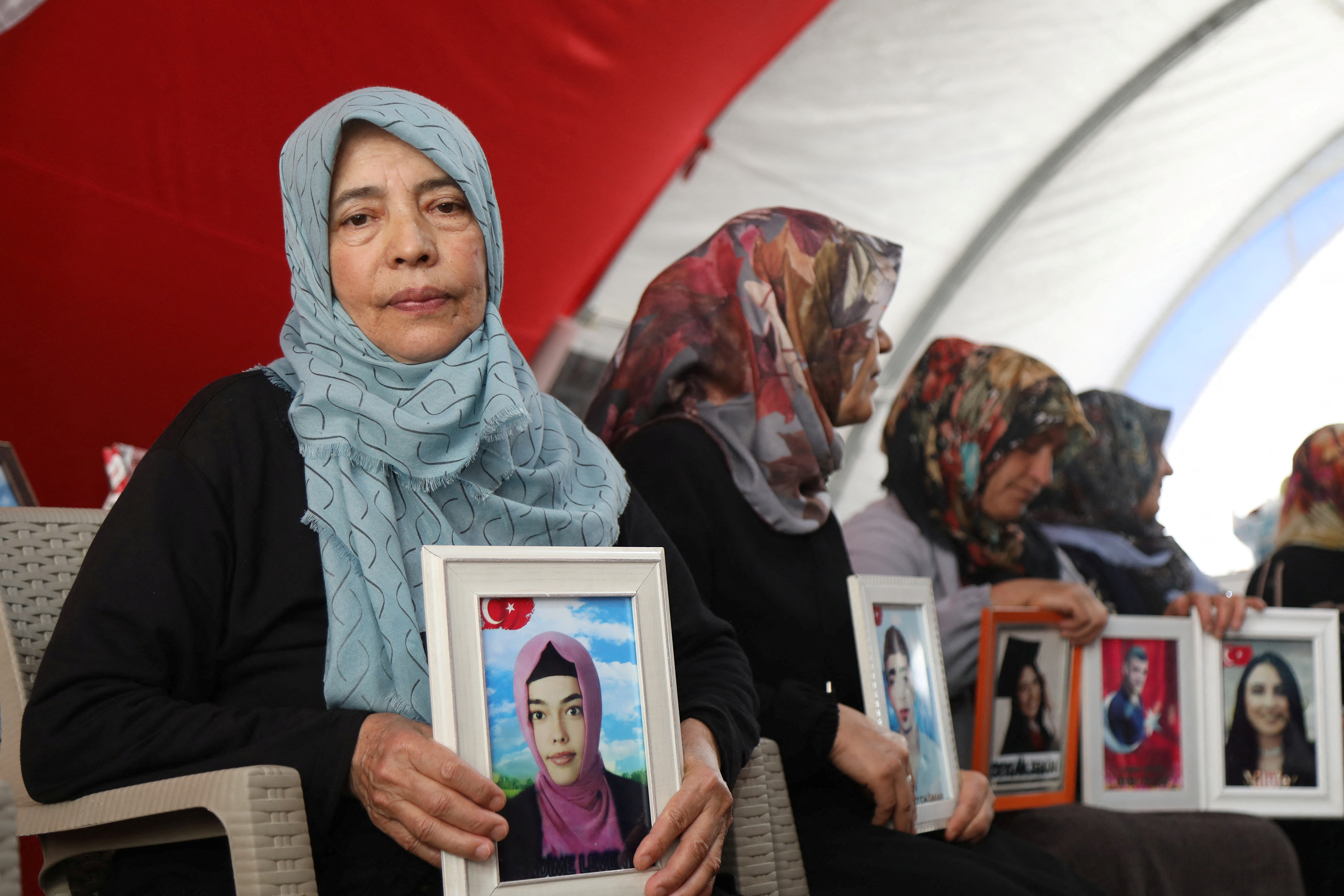 Hatice Levent holds a picture of her daughter Fadime who is believed to have joined the outlawed PKK, during a gathering in Diyarbakir