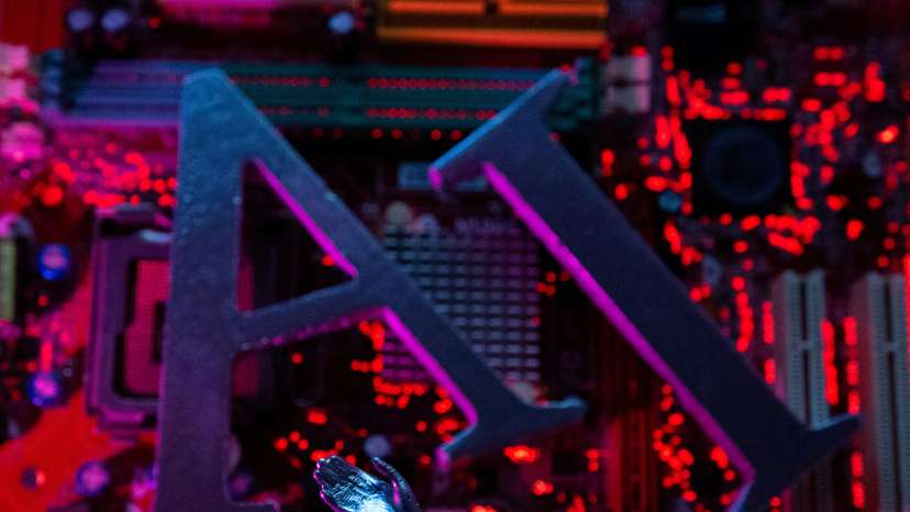 Illustration shows AI (Artificial Intelligence) letters and robot hand