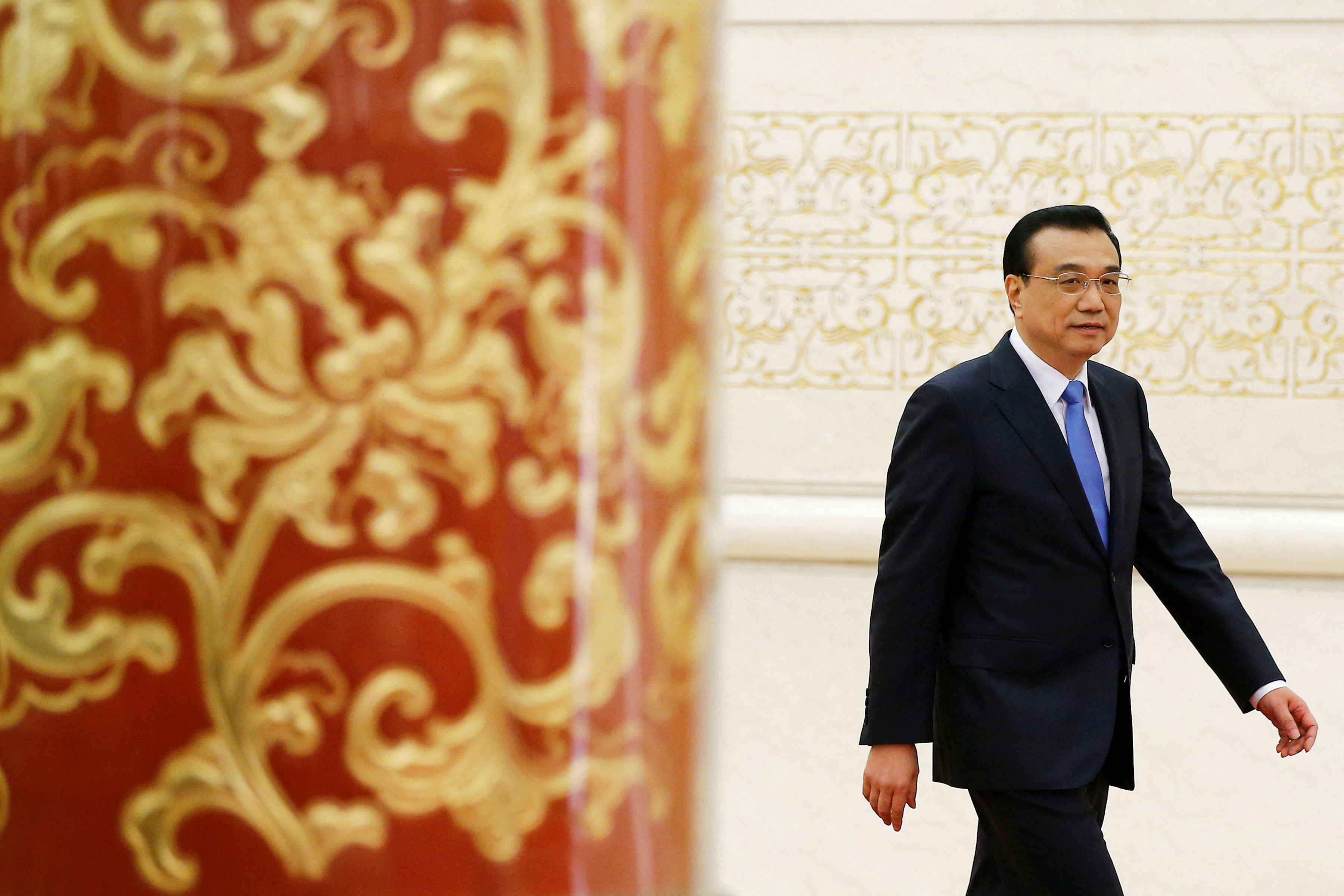 FILE PHOTO: China's Premier Li Keqiang arrives for a news conference after the closing ceremony of China's National People's Congress (NPC) at the Great Hall of the People in Beijing