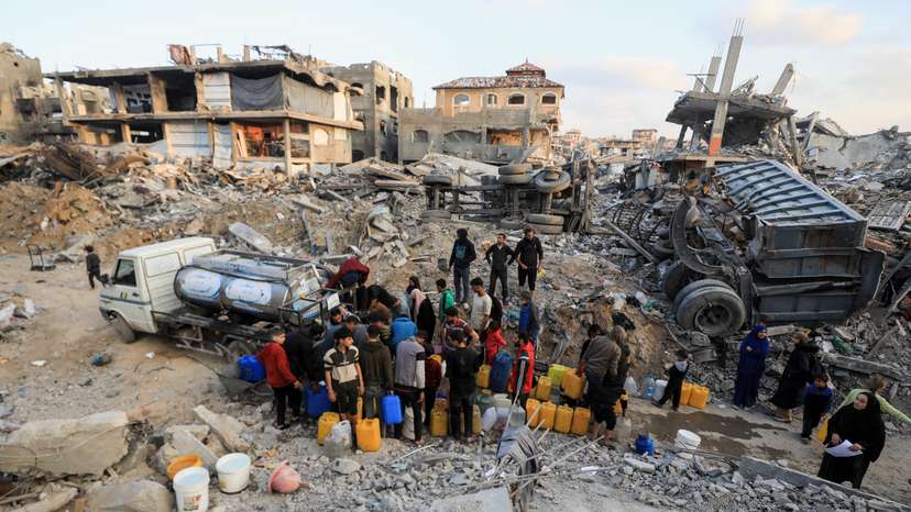 Palestinians fill up containers with water, in Jabalia refugee camp