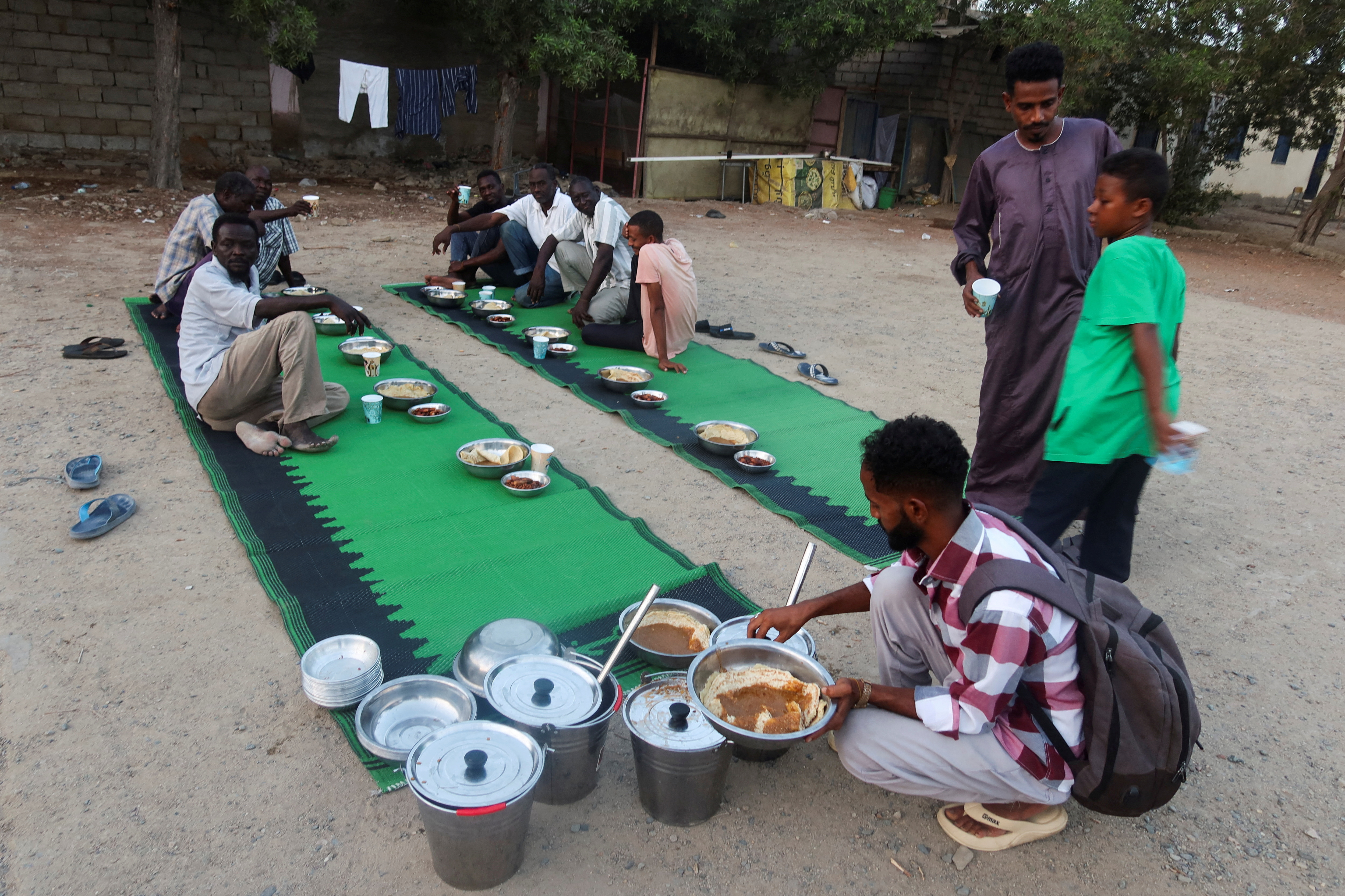 FILE PHOTO: Displaced Sudanese prepare to break their fast at a displacement camp during the month of Ramadan, in the city of Port Sudan
