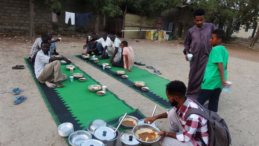 FILE PHOTO: Displaced Sudanese prepare to break their fast at a displacement camp during the month of Ramadan, in the city of Port Sudan