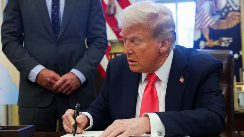 U.S. President Donald Trump signs an executive order in the Oval Office, at the White House in Washington