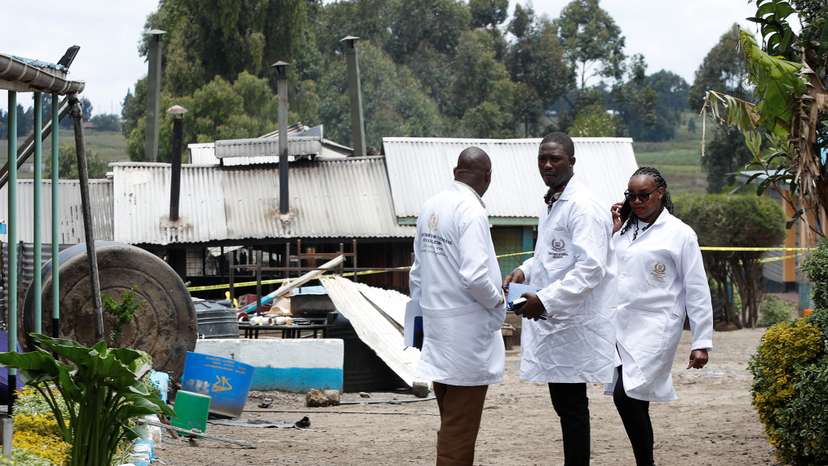 People gather outside the Hillside Endarasha Academy, after fatal fire, in Kieni