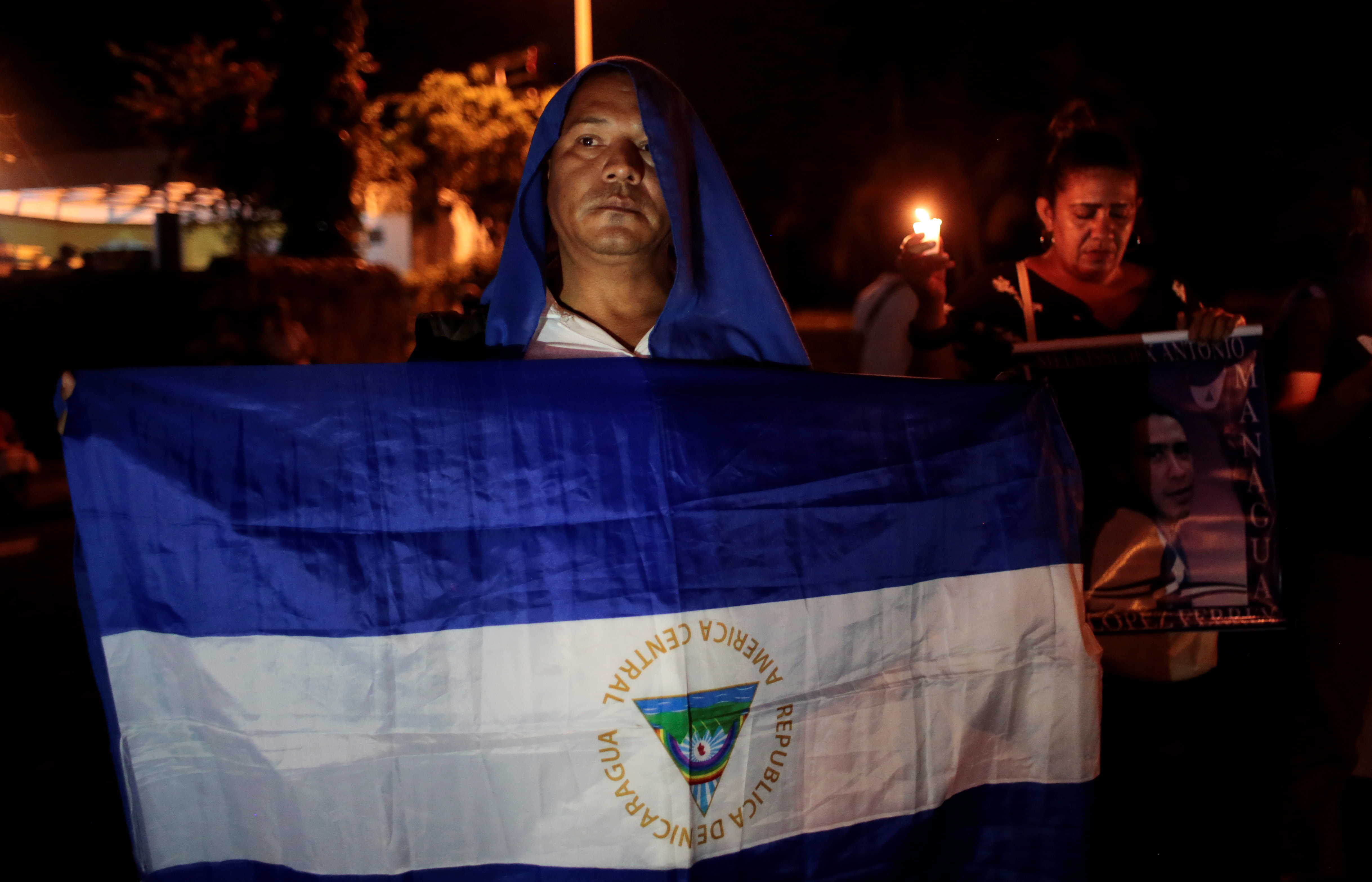 A demonstrator takes part in a  candlelight vigil protest in Manangua