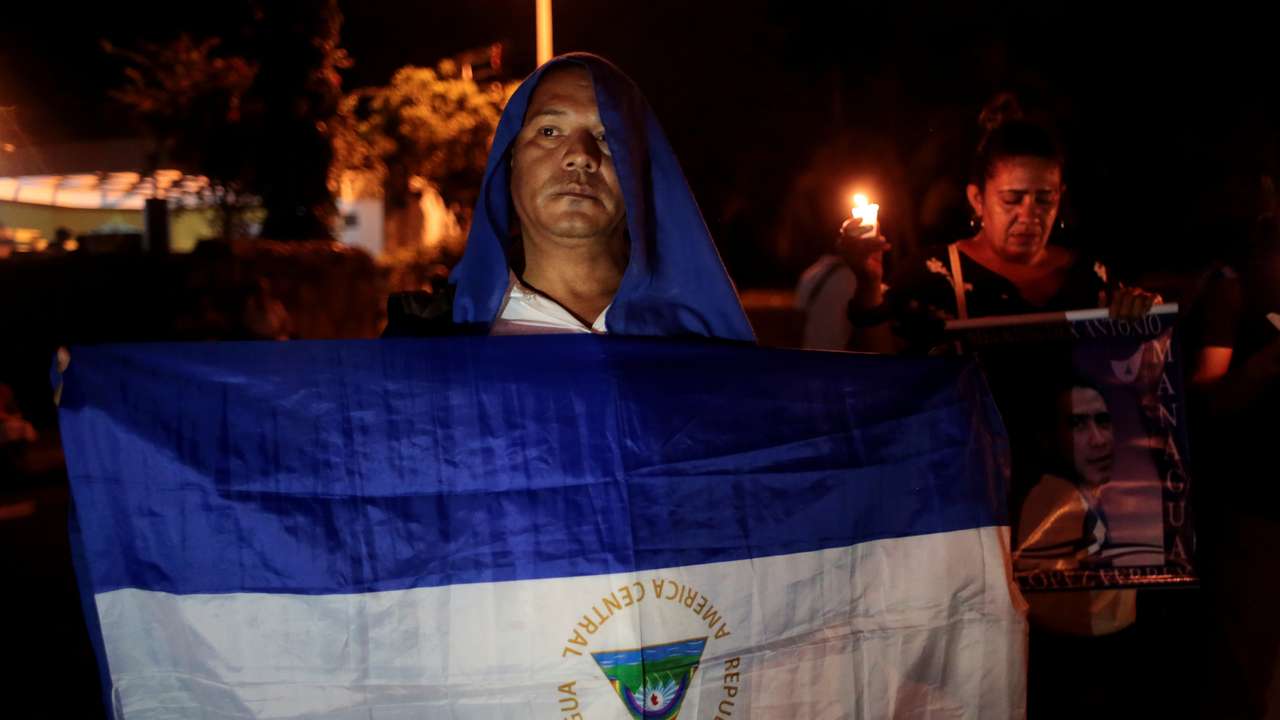 A demonstrator takes part in a candlelight vigil protest in Manangua