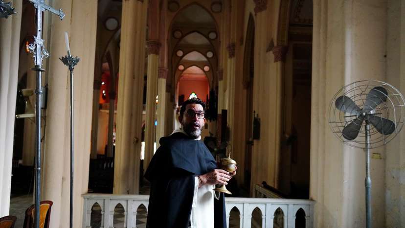 Priest Lester Zayas prepares the church for the Holy Week celebrations in Havana