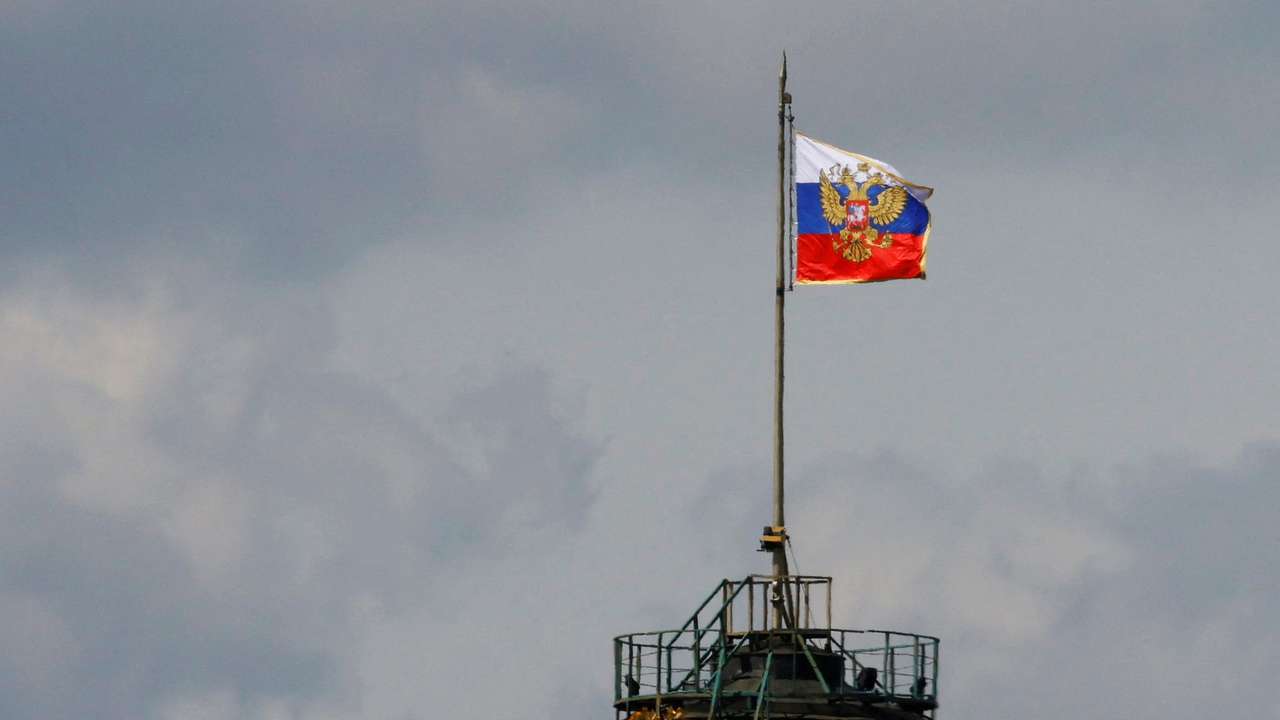The Russian flag flies on the dome of the Kremlin Senate building in Moscow