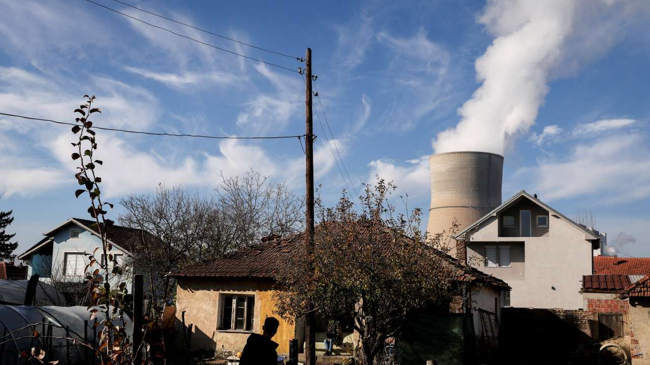 A man walks near the coal-fired power plant, in Obilic