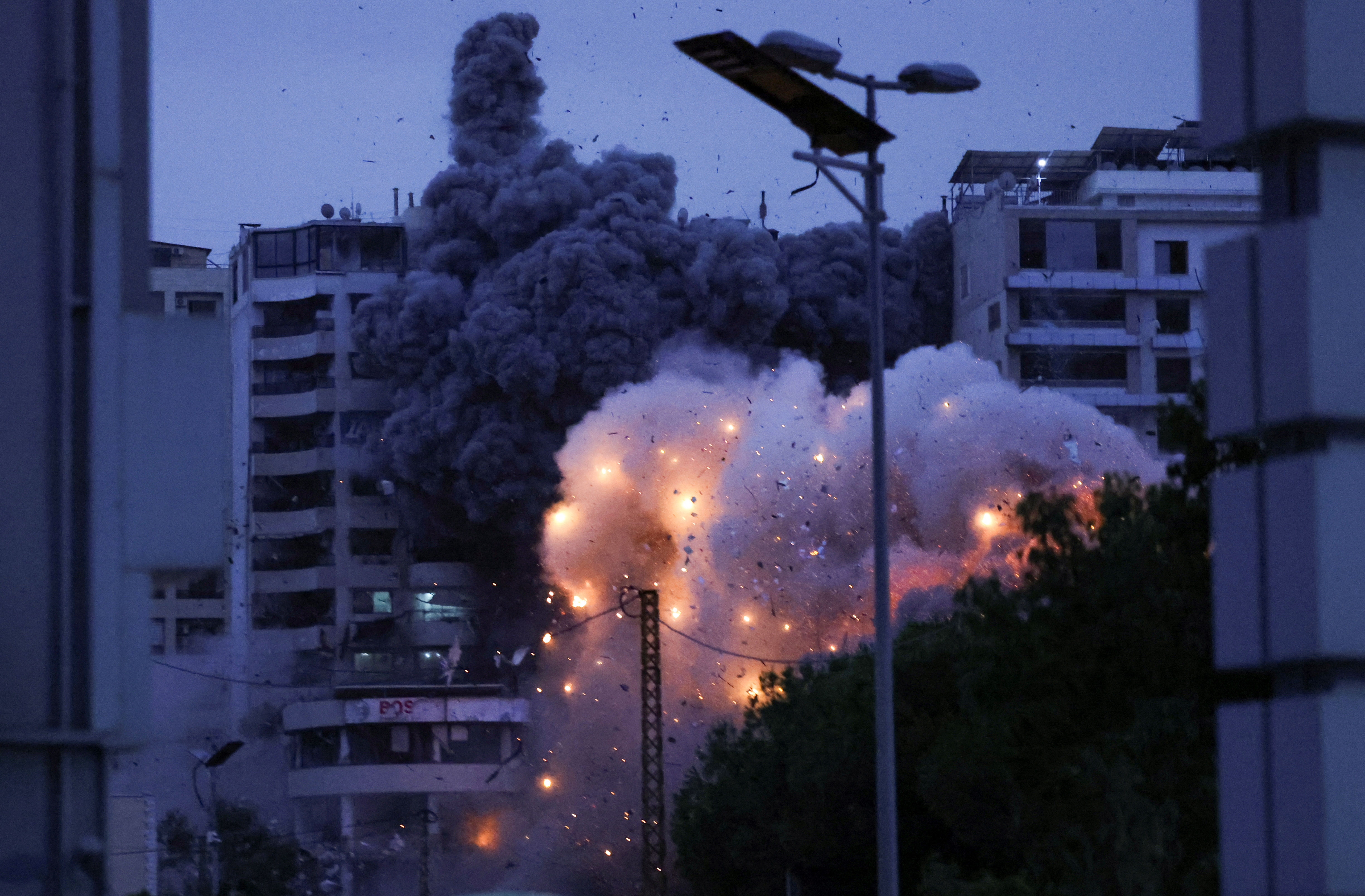 Smoke and flames rise after an Israeli strike, in the Chiyah district of Beirut's southern suburbs
