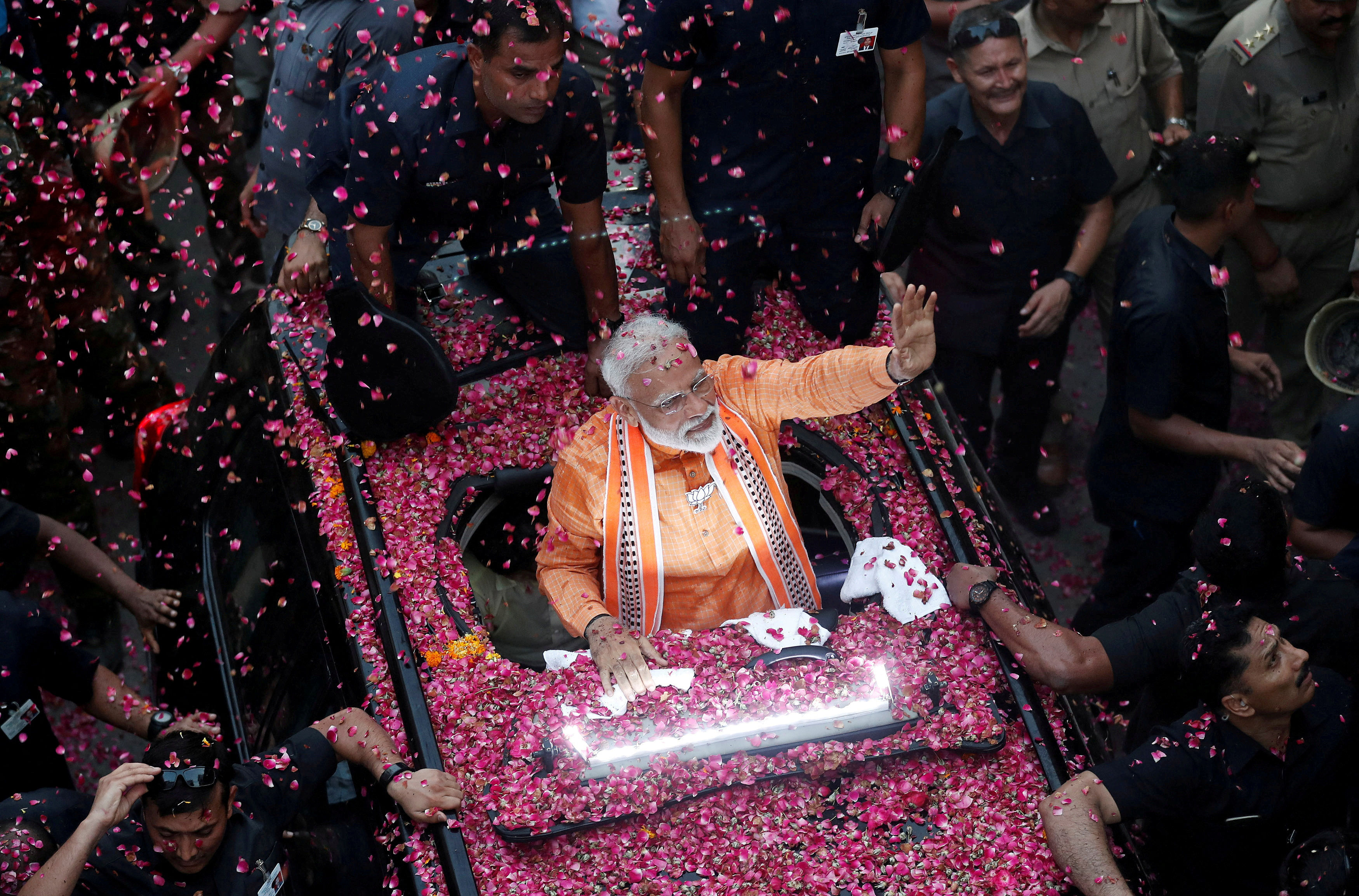 FILE PHOTO: India's Prime Minister Narendra Modi waves to supporters during a roadshow in Varanasi