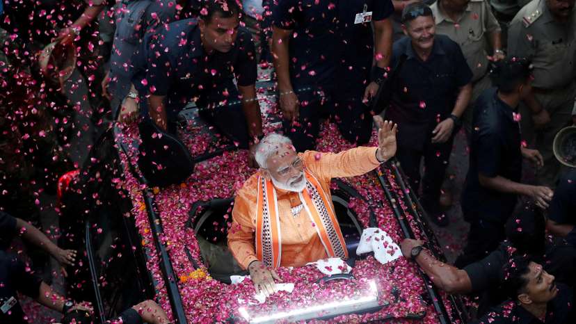 FILE PHOTO: India's Prime Minister Narendra Modi waves to supporters during a roadshow in Varanasi