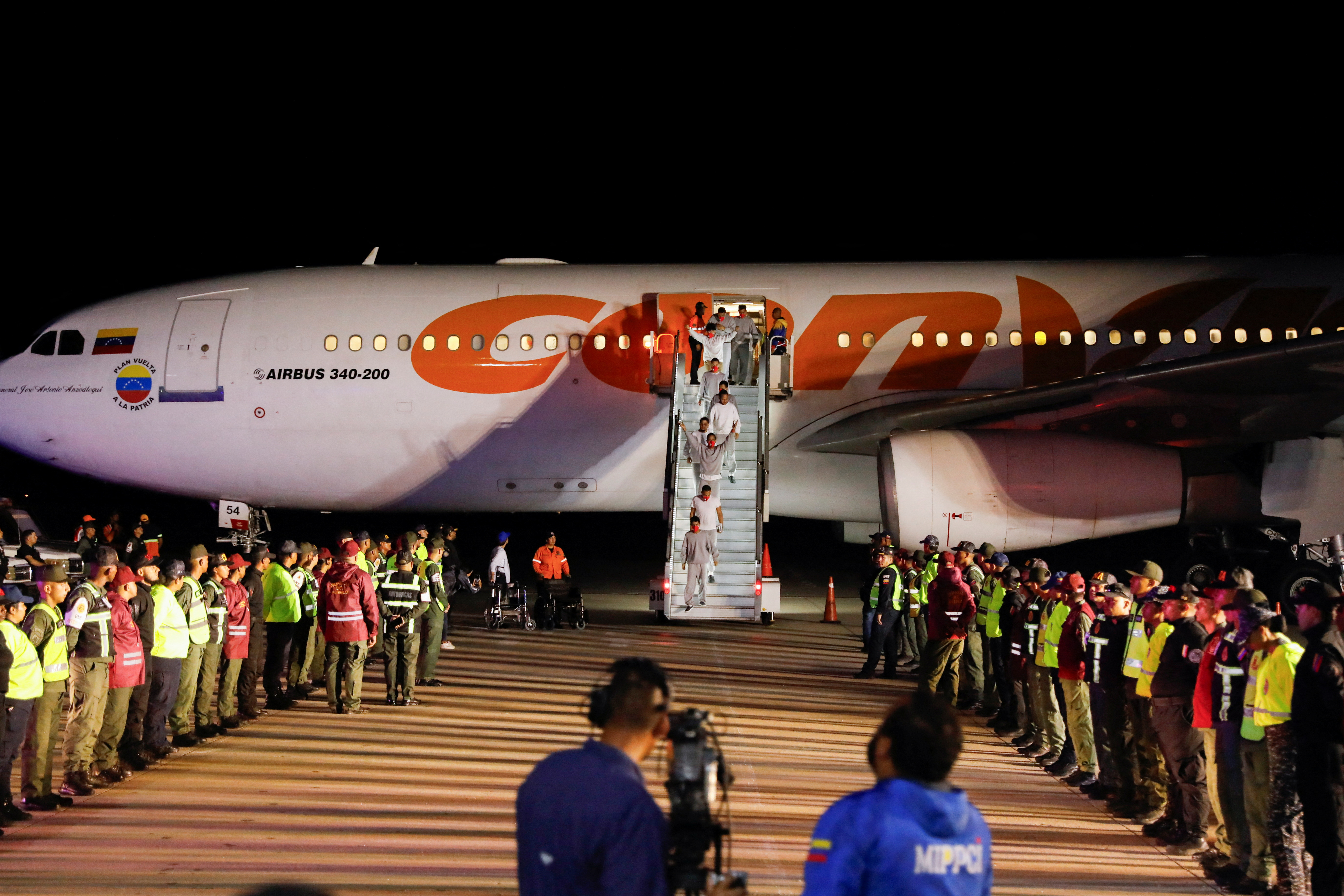 Venezuelan migrants flown home from Guantanamo Bay via Honduras, arrive on a deportation flight at Simon Bolivar International Airport in Maiquetia