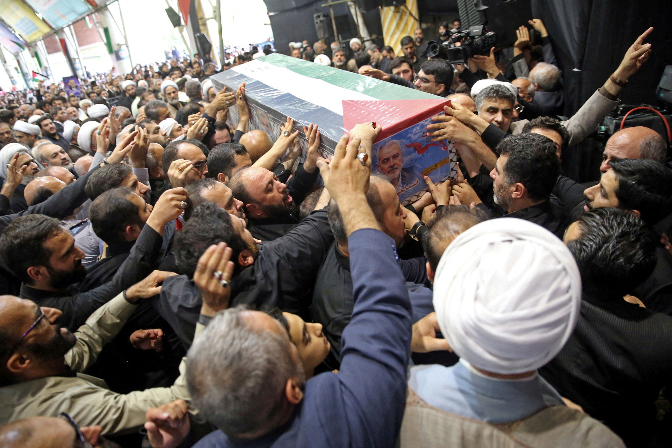 FILE PHOTO: Mourners carry the coffin of assassinated Hamas chief, Ismail Haniyeh during his funeral ceremony in Tehran
