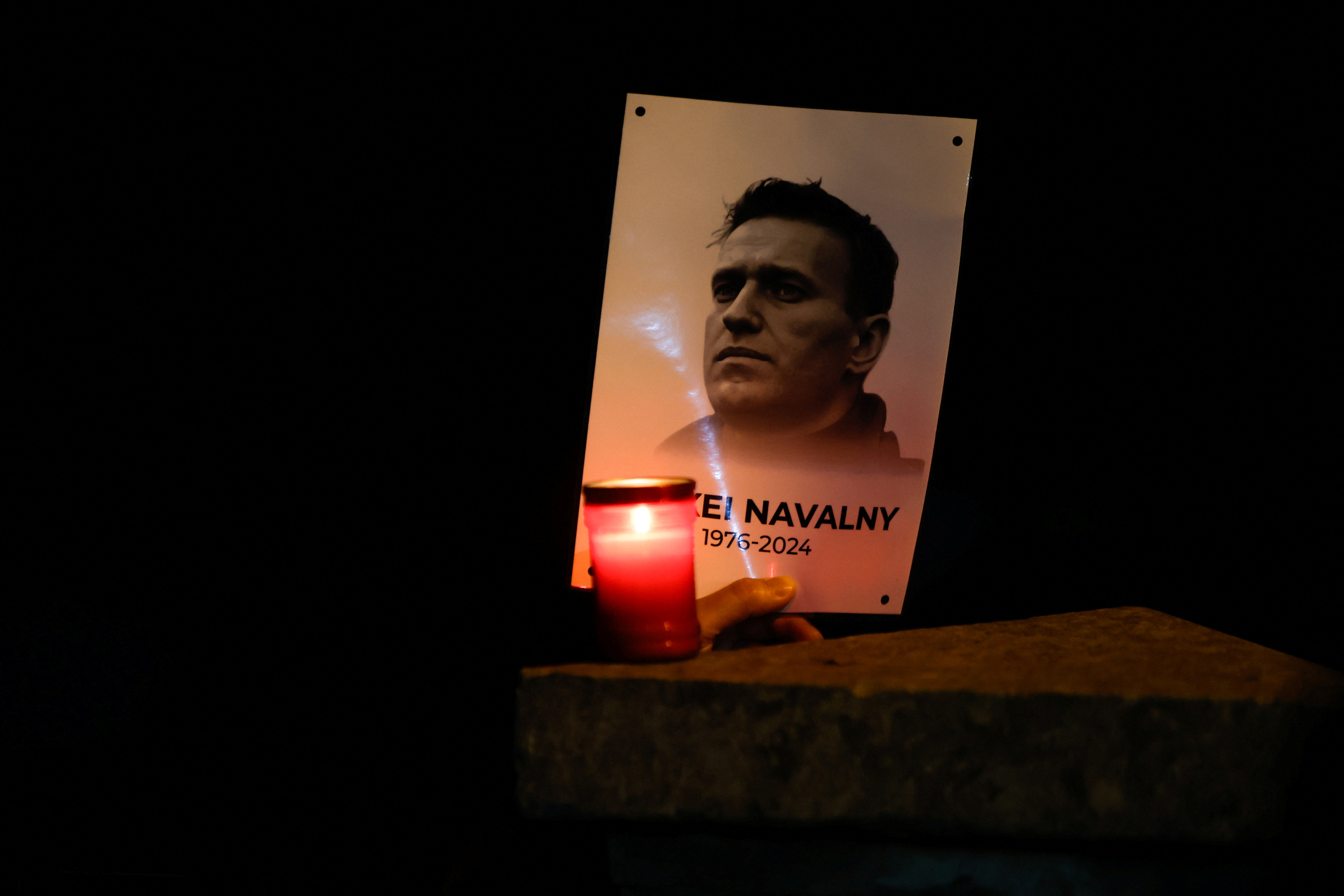 People attend a protest and vigil following the death of Russian opposition leader Alexei Navalny, in Kappara