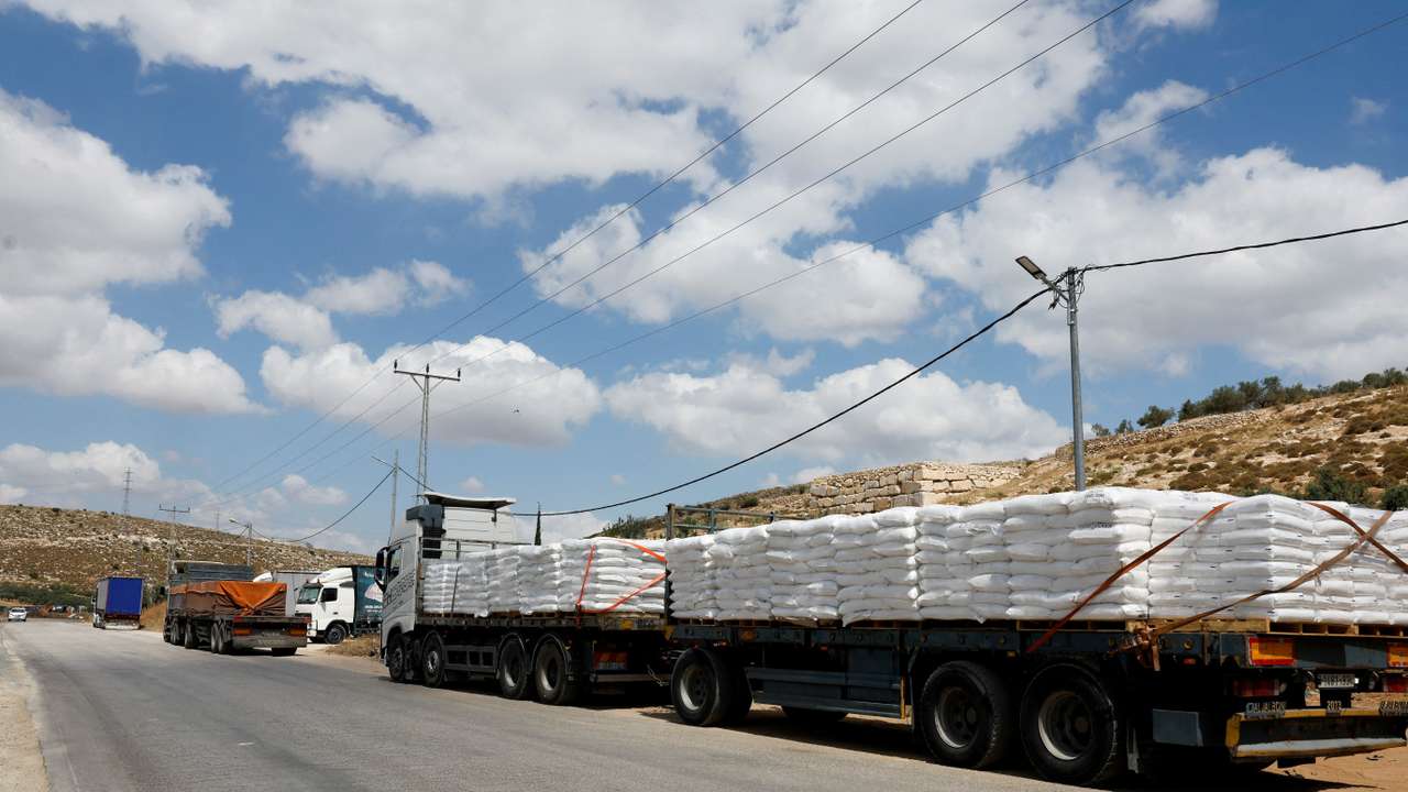FILE PHOTO: Trucks carrying aid to Gaza stand damaged at checkpoint near Hebron