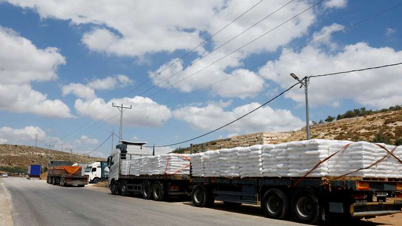 FILE PHOTO: Trucks carrying aid to Gaza stand damaged at checkpoint near Hebron