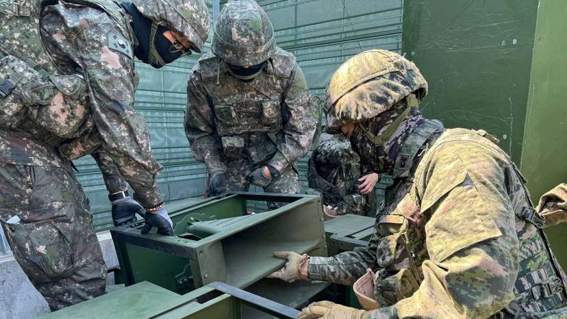 FILE PHOTO: South Korean soldiers work on a loudspeaker that is set up for propaganda broadcasts during a military drill near the demilitarized zone separating the two Koreas in Paju
