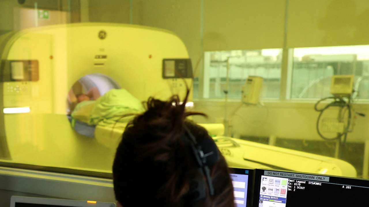 A Nuclear Medicine technologist monitors a cancer patient going through a nuclear medicine scan in a positron emission tomography (PET) at the Molecular Radiotherapy Service at University College London Hospital (UCLH), in London, Britain, January 29, 2025. REUTERS/Isabel Infantes