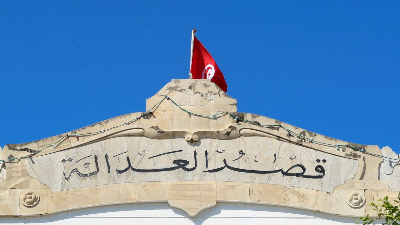 FILE PHOTO: A Tunisian flag flutters atop of the Palace of Justice building in Tunis