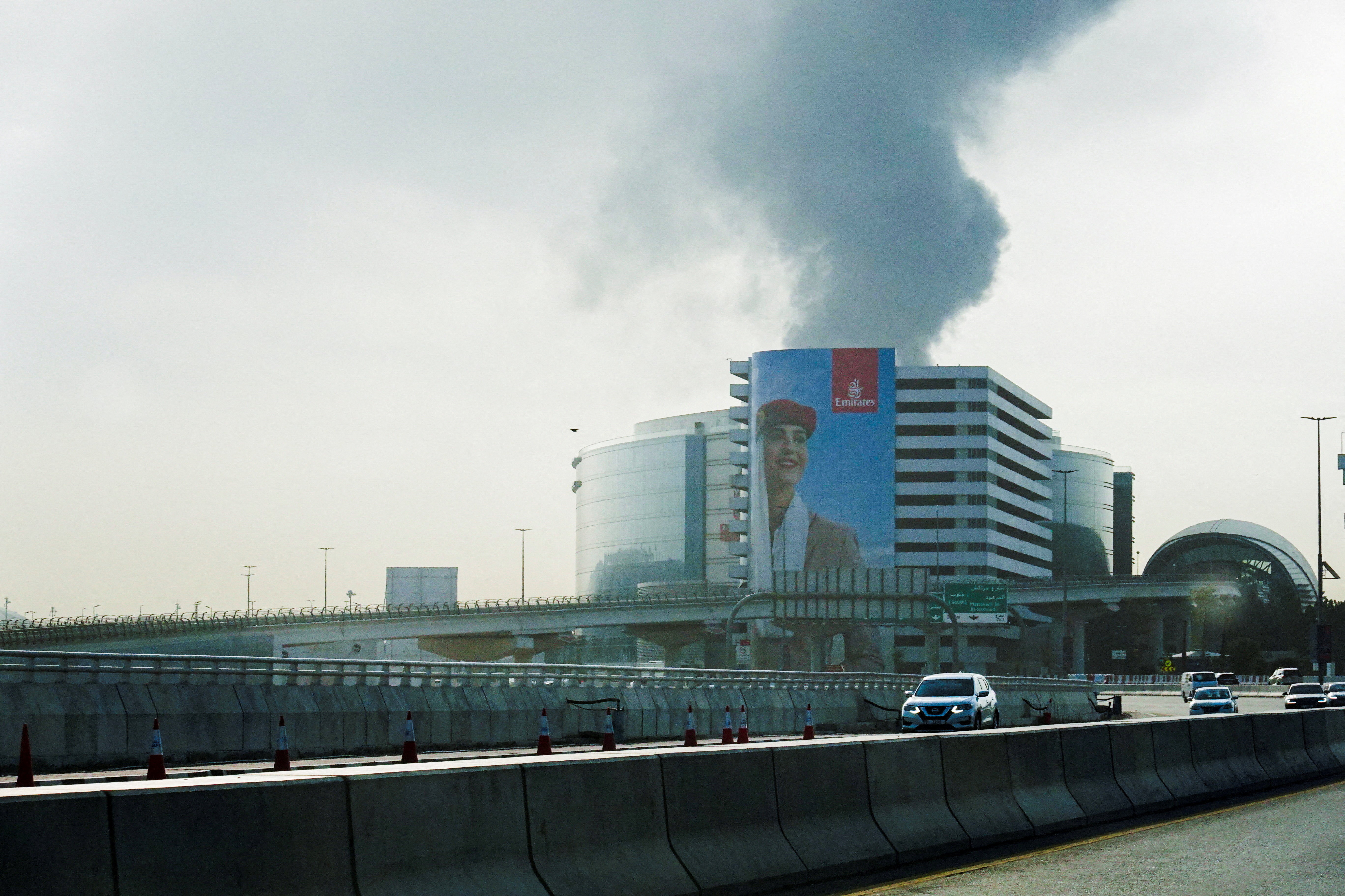 Smoke rises from the Dubai International Airport