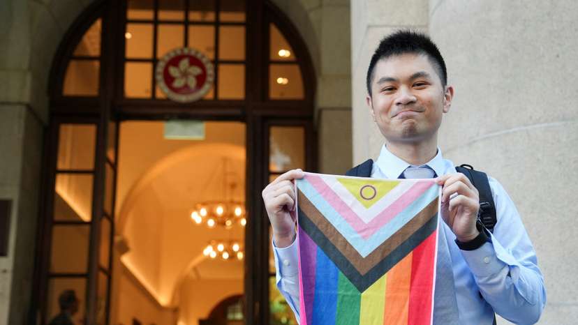 Nick Infinger holds intersex-inclusive pride progress flag after Hong Kong's top court rules in favour of equal housing and inheritance rights for same-sex couples in Hong Kong