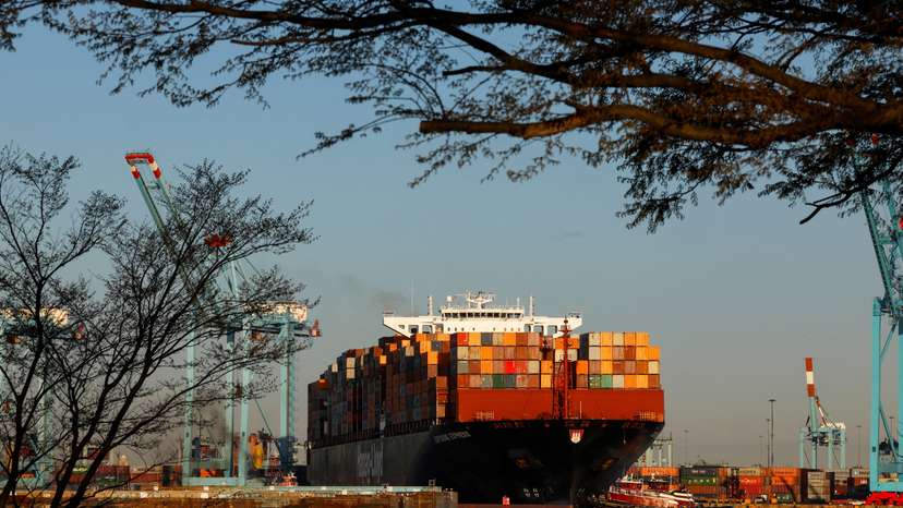 A cargo ship sits outside of the Port of Elizabeth marine terminal seen from Bayonne, New Jersey