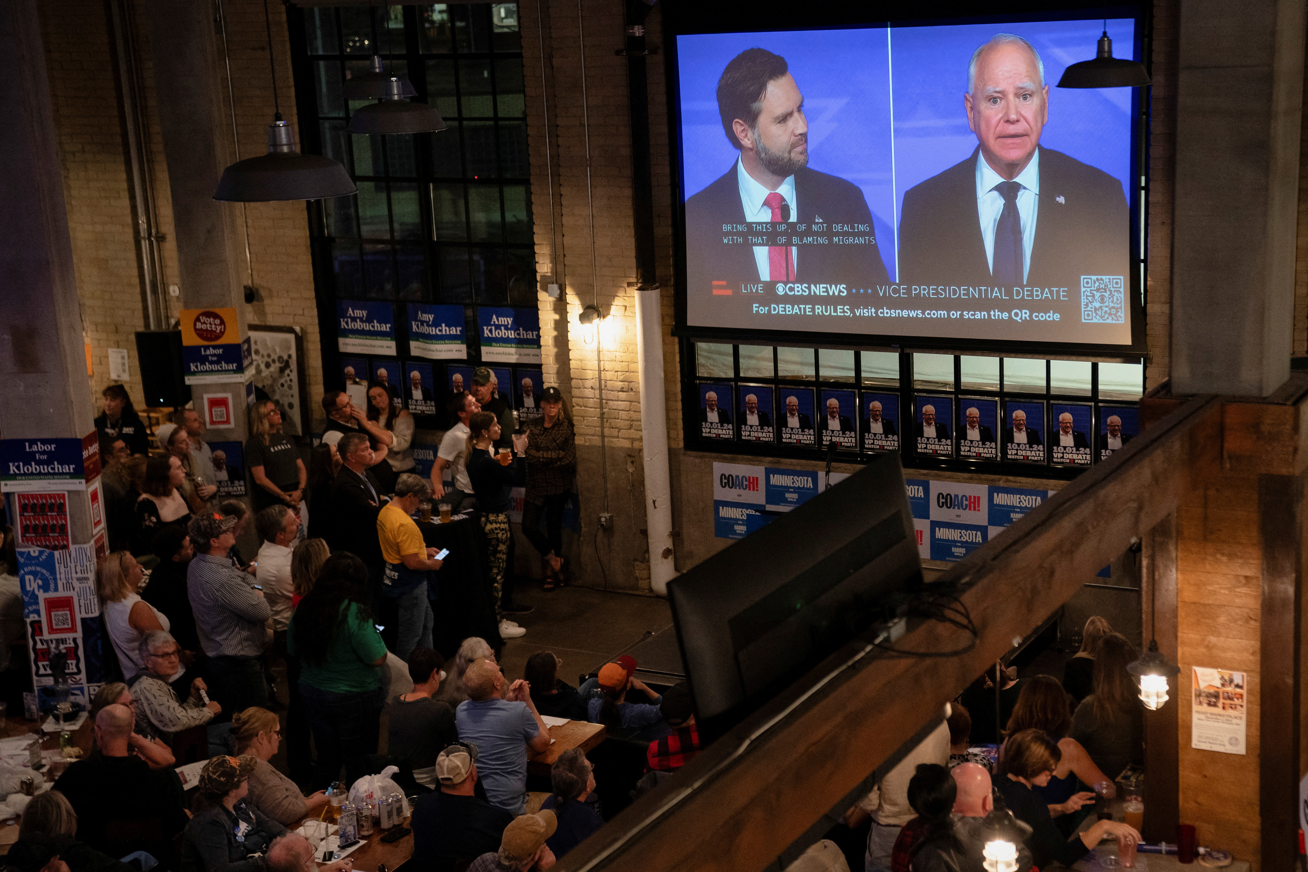 People watch the Vice Presidential debate, in St. Paul