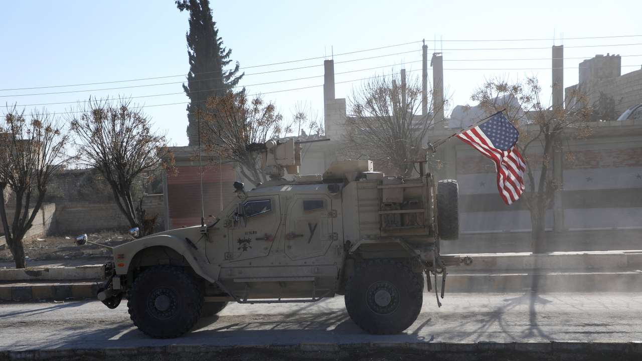 A U.S. military vehicle moves on a road on the day of a meeting between the Syrian Democratic Forces (SDF) leaders and U.S. military leaders, in Deir Hafer