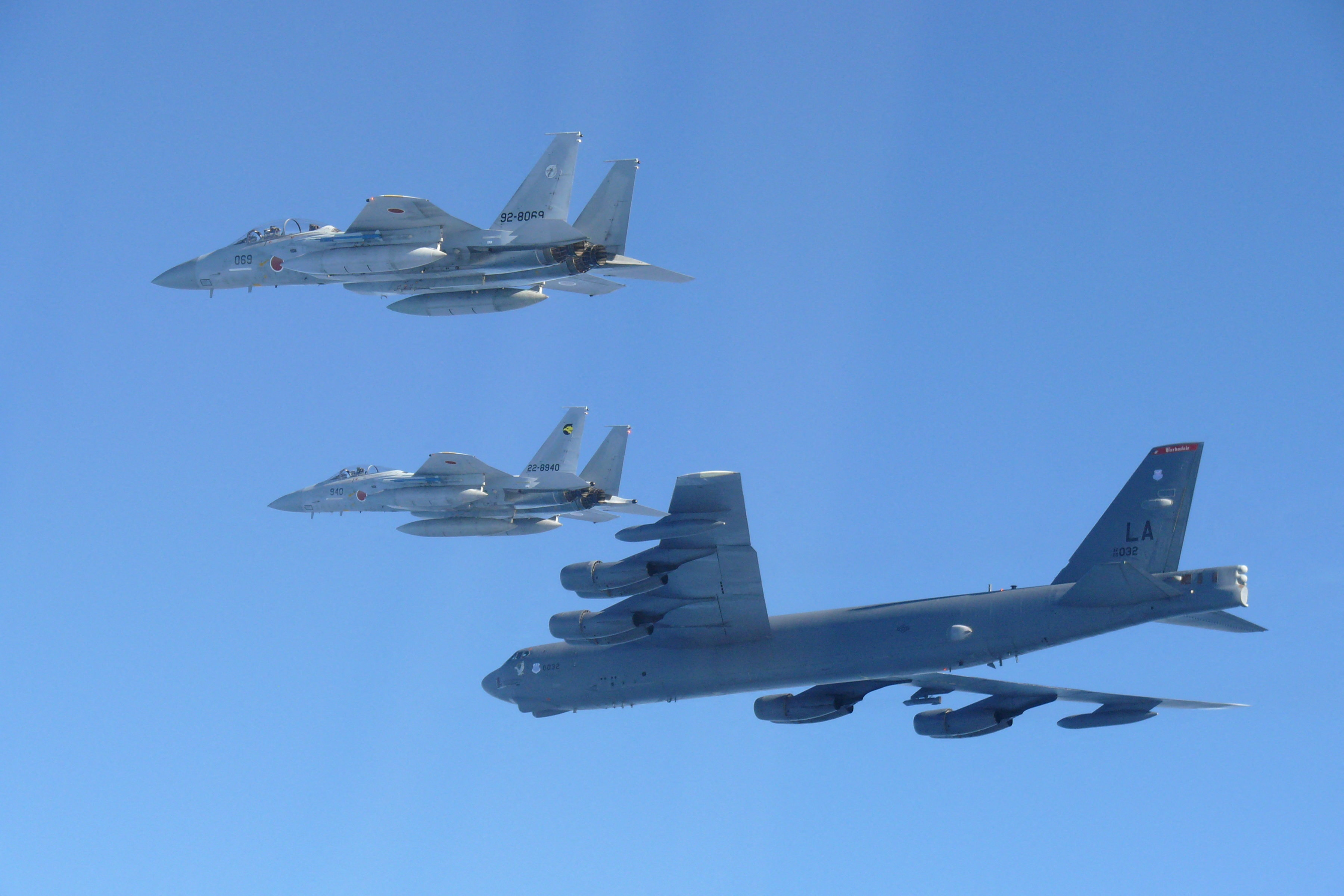 Handout photo shows Japan Air Self-Defense Force's F-15 fighters hold a joint military drill with the U.S. B-52 bomber over Sea of Japan