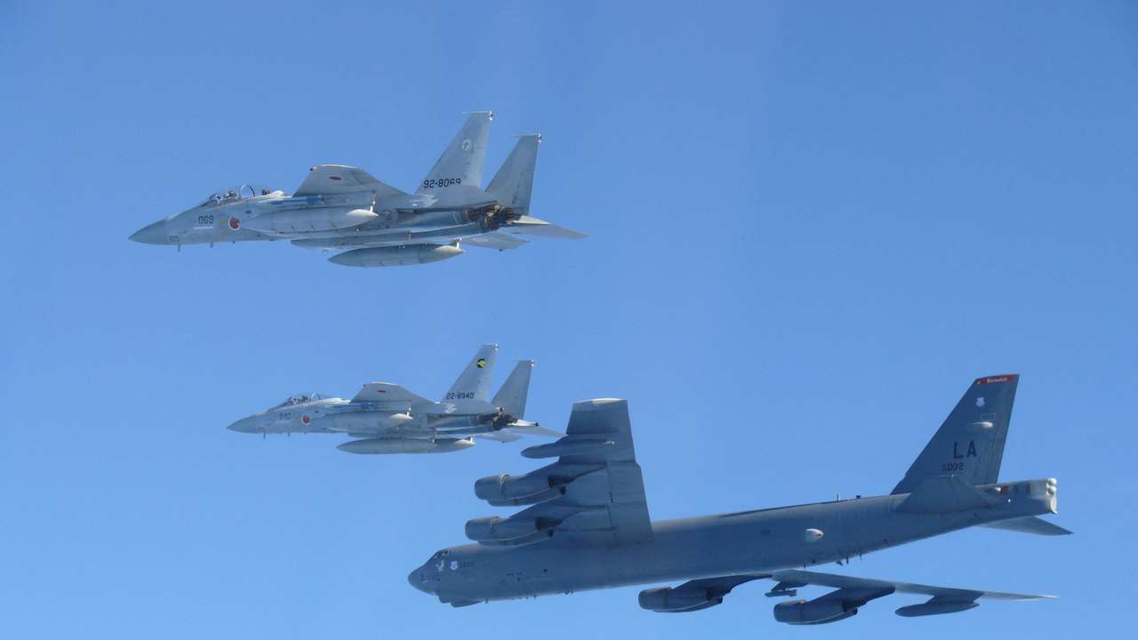Handout photo shows Japan Air Self-Defense Force's F-15 fighters hold a joint military drill with the U.S. B-52 bomber over Sea of Japan